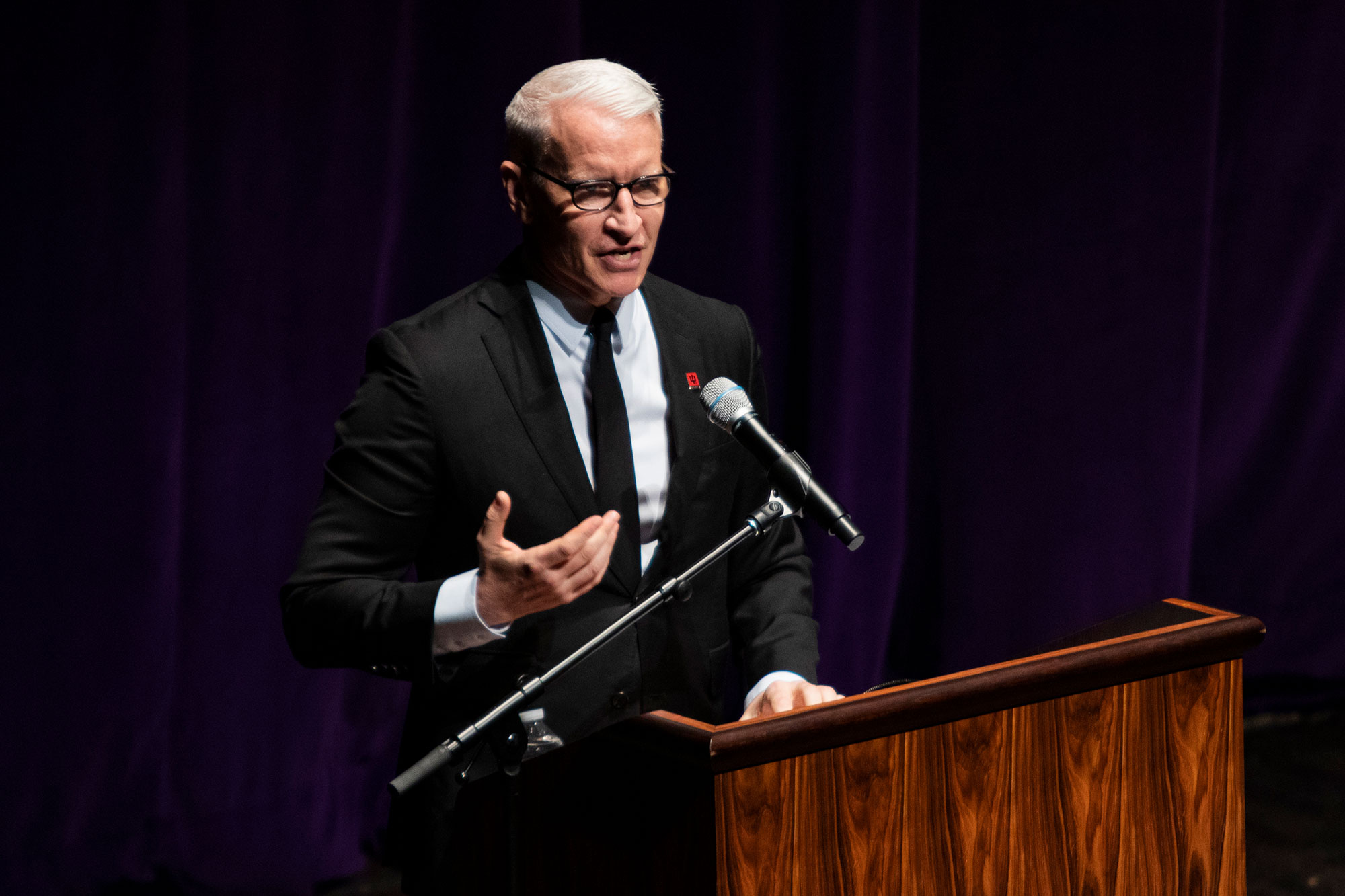 Anderson Cooper speaks at a podium.