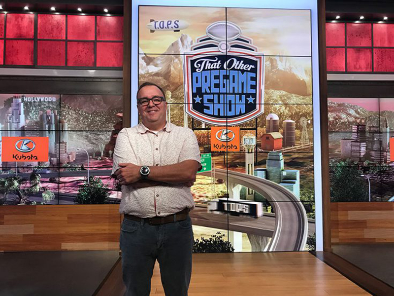 Jay Kincaid smiles in front of a CBS show intro screen.