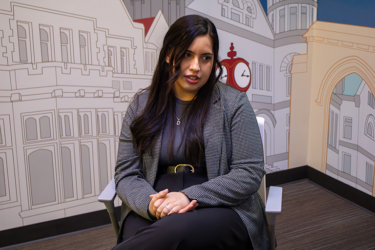 Daniela Molina sits in a chair.